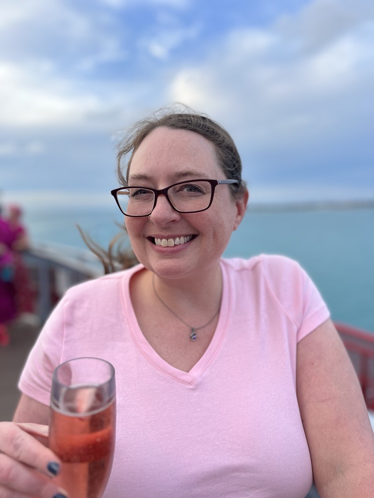 Kelly sitting with a flute of Champagne