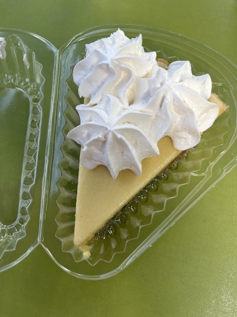 A slice of key lime pie with three dollops of whipped topping. From Kermit's Key West Key Lime Shoppe