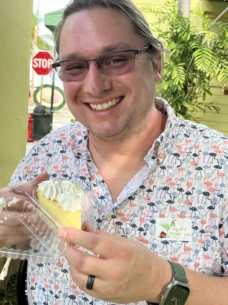 Dustin holding a slice of key lime pie.