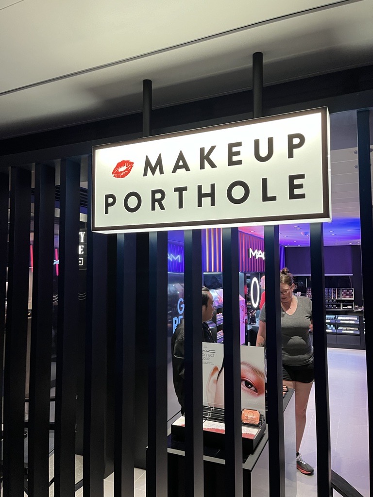Makeup store onboard the Scarlet Lady called Makeup Porthole with a lipstick kiss emoji