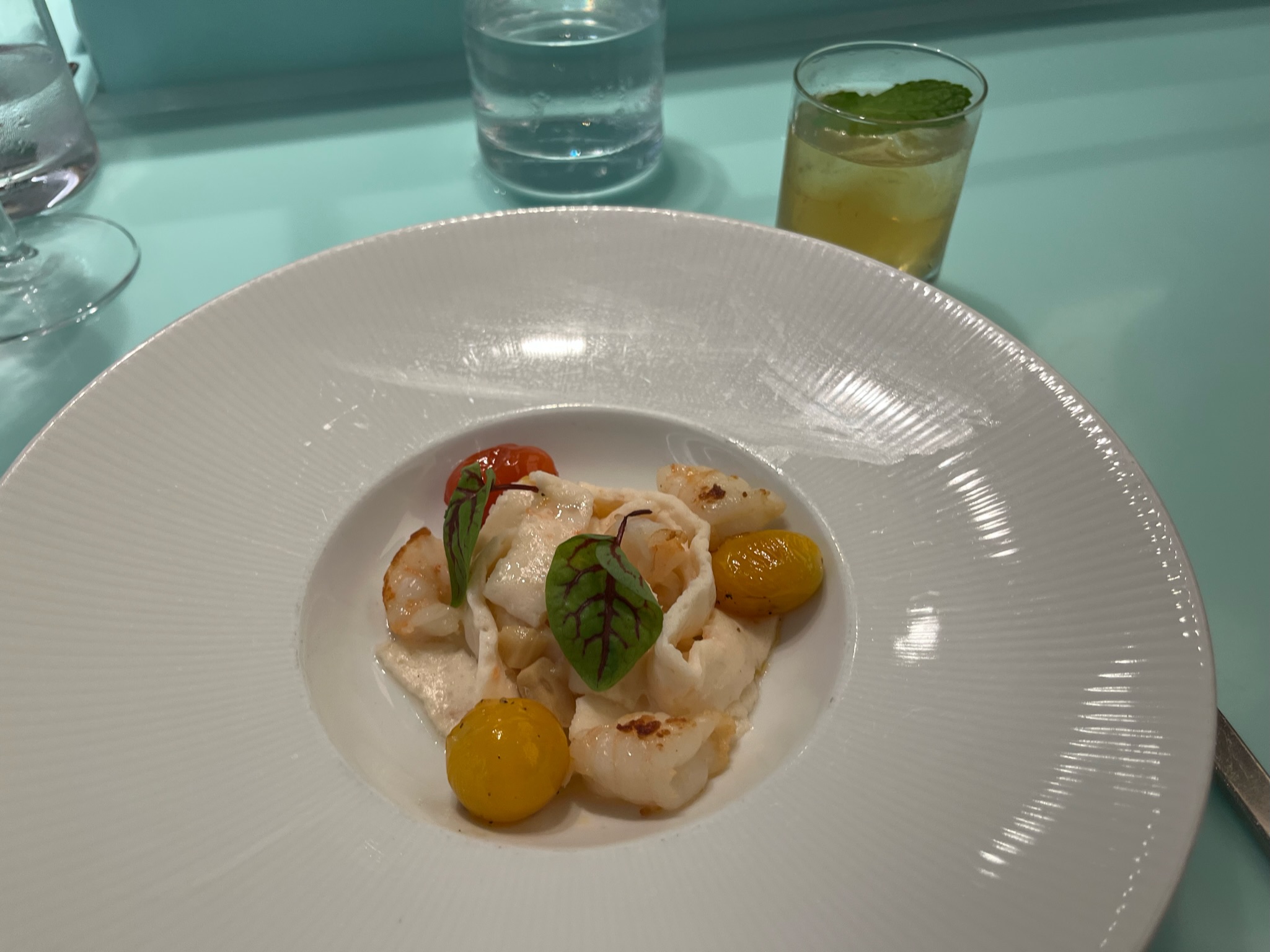 A seafood dish at Test kitchen with non-alcoholic beverage pairing.
